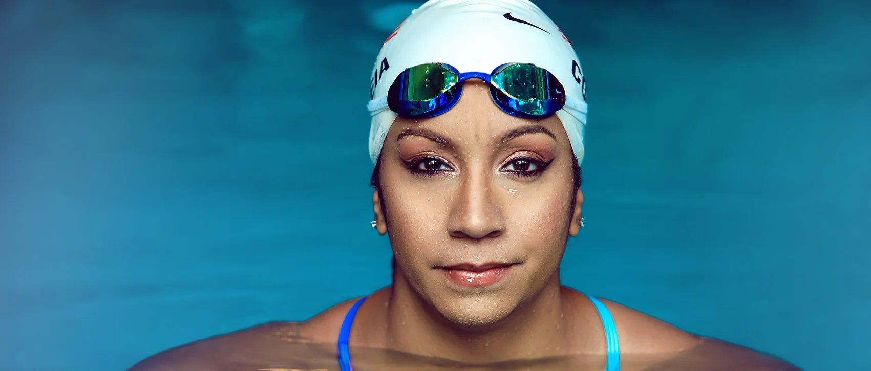 Maritza in pool with eyes locked on camera